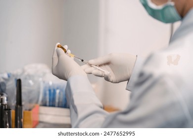 surgery doctor preparing filling syringe medicine for procedure. medical staff preparing therapy operation by adding liquid from vial. cosmetologist ready medicine syringe needle for plastic surgery. - Powered by Shutterstock