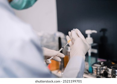 surgery doctor preparing filling syringe medicine for procedure. medical staff preparing therapy operation by adding liquid from vial. cosmetologist ready medicine syringe needle for plastic surgery. - Powered by Shutterstock