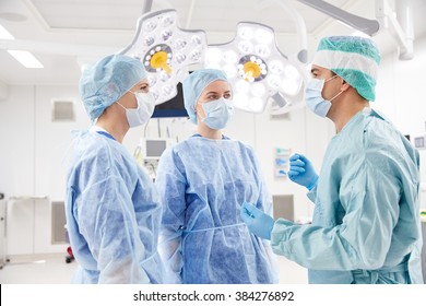surgery, medicine and people concept - group of surgeons in operating room at hospital - Powered by Shutterstock