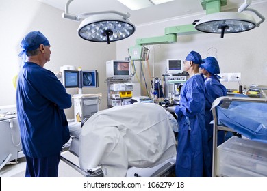 Surgery With Operating Table, Nurses And Surgeon