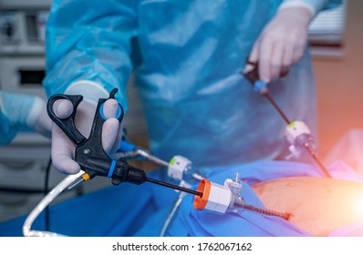 Surgery operation with modern equipment. Selective focus on doctor`s hands with special robotic equipment.