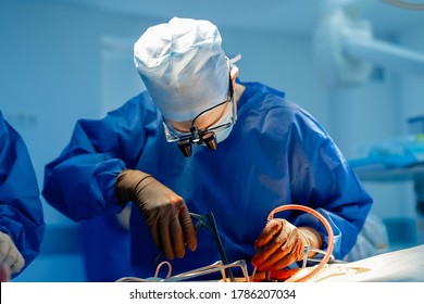 Surgery operation. Surgeon in operating room with robotic surgery equipment. Medical background, selective focus.