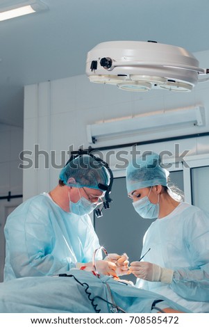 Surgery team operating nose in a surgical room