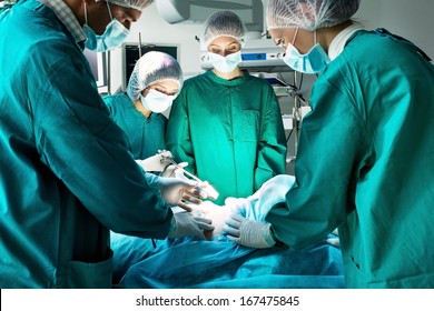 Surgery team operating in a surgical room - Powered by Shutterstock