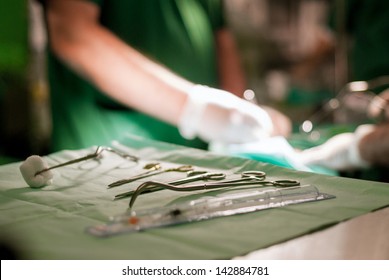 Surgery tools on table with doctor on background