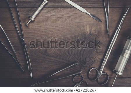 surgical armaments on the brown wooden table background