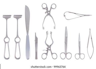 Surgical instruments with different scalpels scissors and spreader over a white background