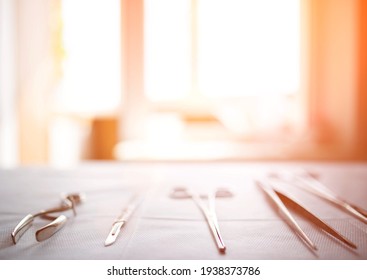 Surgical Instruments On The Table In The Operating Room Of The Hospital. Sunny Sunset In The Window. Surgery Concept, Amputation, Complications After Surgery. Copy Space For Text, Transplant