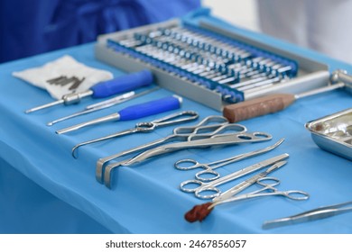 Surgical instruments in the operating room. Orthopedics and traumatology. The process of surgery. Bone impactor, hooks, raspatory, elevators, chisels, osteotomes, scissors, bone hammer on the table. - Powered by Shutterstock