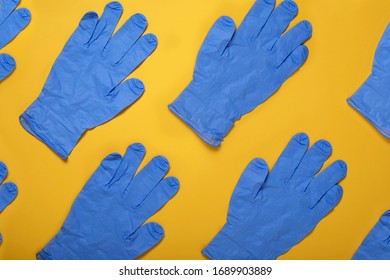 Surgical Latex Gloves On Yellow Background, Flat Lay. Coronavirus Prevention, Medical Supplies Shortage