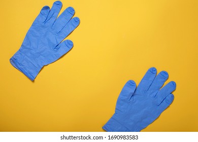 Surgical Latex Gloves On Yellow Background, Flat Lay. Coronavirus Prevention, Medical Supplies Shortage