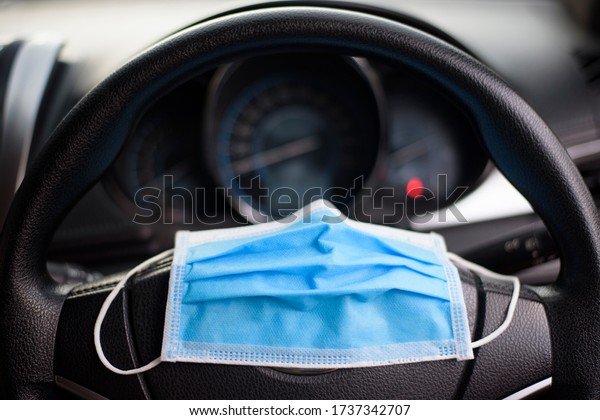 Surgical mask\
in car , Covid-19 protection concept\
