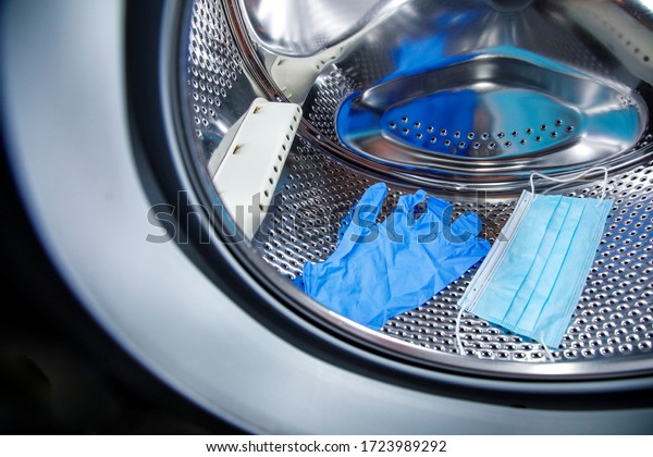 surgical mask and latex gloves in the washing\
machine drum