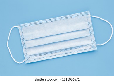 Surgical mask with rubber ear straps. Typical 3-ply surgical mask to cover the mouth and nose. Procedure mask from bacteria. Protection concept. - Shutterstock ID 1611086671