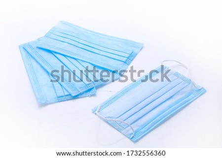 Surgical or medical mask with rubber ear straps. Typical 3-ply doctor mask to cover the mouth and nose. Doctor Medical face blue mask protection.face mask photography on white background