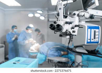 Surgical microscope in operating room with doctors. Ophthalmological clinic. Microsurgical optical equipment - Shutterstock ID 2271376671