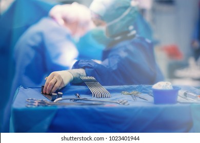 Surgical Nurse Pick Up Sterile Instrument In The Surgery Operation Room In Hospital Processing Technician And Surgical Instrument Technician, Surgical Technician Operating Room Technician Nurse.