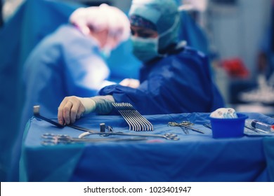 Surgical Nurse Pick Up Sterile Instrument In The Surgery Operation Room In Hospital Processing Technician And Surgical Instrument Technician, Surgical Technician Operating Room Technician Nurse.