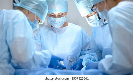 Surgical operating team performing thoracic surgery in modern hospital, health