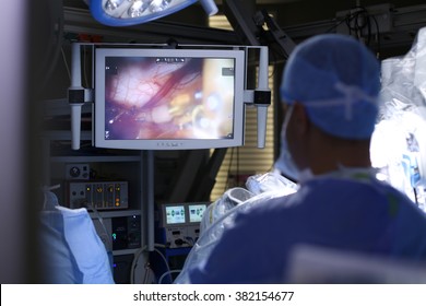 Surgical operation robot. Medical operation involving robot. Robotic Surgery. Manipulators performing surgery on a man. Surgical operation robot.