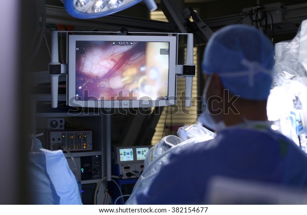 Surgical operation robot. Medical\
operation involving robot. Robotic Surgery. Manipulators performing\
surgery on a man. Surgical operation\
robot.