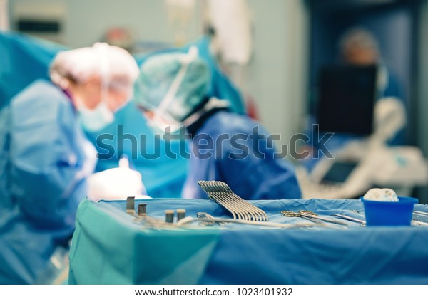 Surgical room in hospital with medical team of\
surgeons doing minimal invasive surgical interventions. Surgery\
operating room with electrocautery equipment for cardiovascular\
emergency surgery\
center