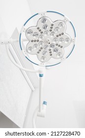 Surgical Round Light. Medical Led Ceiling Lamp. Empty Operating Room In A Hospital With Treatment Table Lamp. Blank Emergency Surgery Room Concept. Surgical Equipment. Clinic Interior For Background.