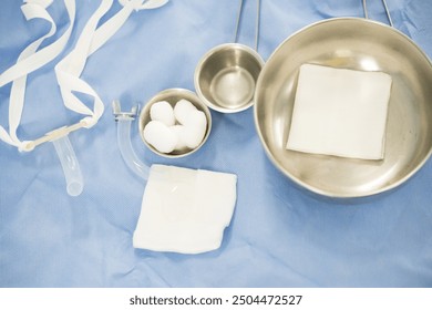 Surgical set and medical equipment on blue surgical tray inside operating room.Sterile surgical instrument tool equipment for surgery.Infection control. - Powered by Shutterstock