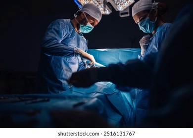 The surgical team operates with focused precision, utilizing advanced tools and a well-lit environment, ensuring patient safety and successful outcomes through their expertise and coordination. - Powered by Shutterstock