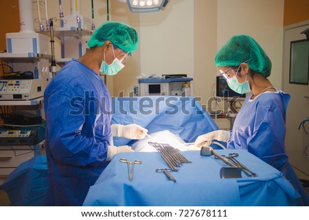 The surgical team is performing surgery for the patient in the operating room.
