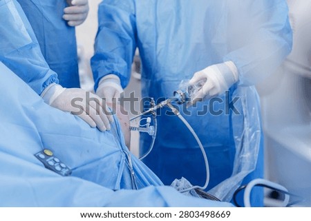 A surgical team performs knee arthroscopy to address meniscus issues, showcasing minimally invasive techniques and advanced medical equipment in an operating room.