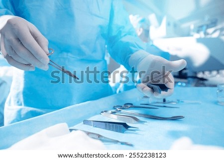 Surgical Team Preparing Instruments for Precision Medical Procedure in Operating Room.