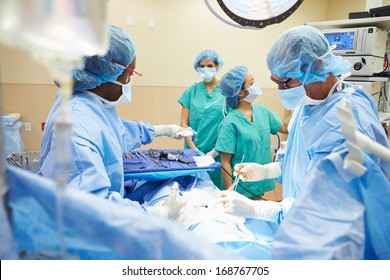 Surgical Team Working In Operating Theatre