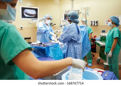 Surgical Team Working In Operating Theatre