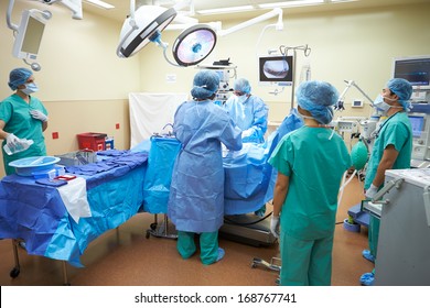 Surgical Team Working In Operating Theatre