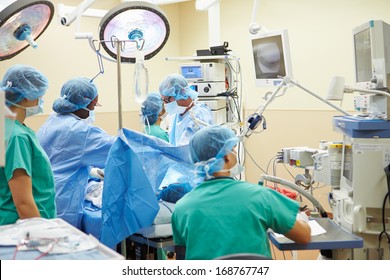 Surgical Team Working In Operating Theatre