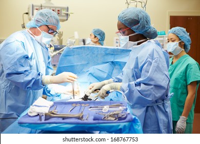 Surgical Team Working In Operating Theatre