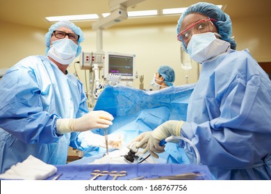 Surgical Team Working In Operating Theatre - Shutterstock ID 168767756