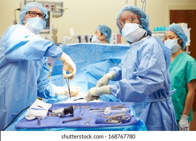 Surgical Team Working In Operating Theatre - Shutterstock ID 168767780
