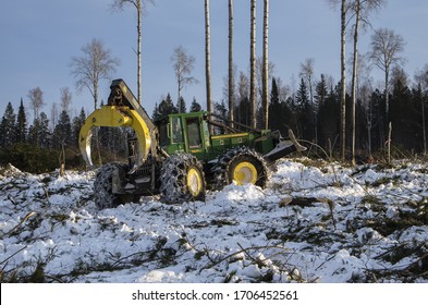 Surgut, Khanty-Mansi Autonomous Okrug / Russia - 01.31.2015: Mechanized felling clearing. John Deere 748H skidder at work.