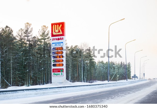 Surgut, Russia-01.25.2020: Information board\
of Lukoil gas station on the road, winter fuel prices.Ecological\
fuel transfer,blurred\
background