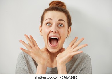 Surprise astonished woman. Closeup portrait woman looking surprised in full disbelief wide open mouth isolated grey wall background. Positive human emotion facial expression body language. Funny girl