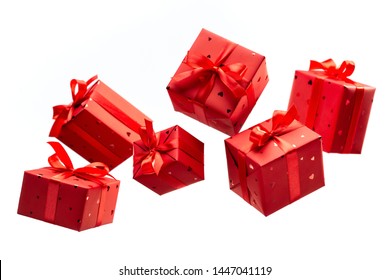 Surprise in flying boxes wrapped in red gift paper with bow on white background. Concept of holidays and greeting cards. Copy space.	
