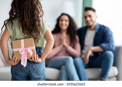 Surprise For Mommy. Little Girl Holding Gift Box Behind Back - Powered by Shutterstock