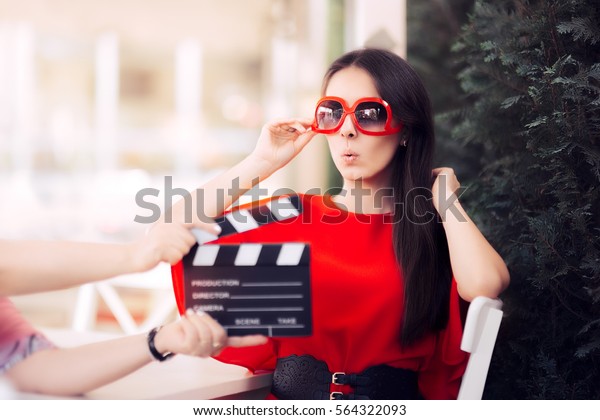 Surprised Actress with Oversized Sunglasses\
Shooting Movie Scene - Diva in red dress and big shades starring in\
an artistic film\
