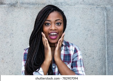 Surprised african woman looking at camera