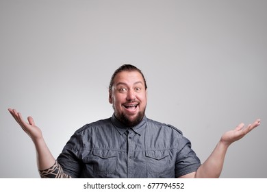Surprised and amazed looking The man naively laid his hands in the sides. - Shutterstock ID 677794552