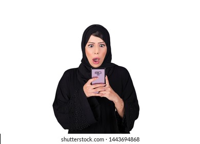 Surprised arab woman using smartphone. Isolated on white background. Arabic technology concept.