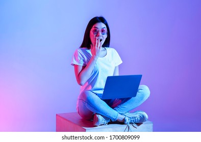 Surprised Asian Girl In Glasses, With Laptop Closed Her Mouth With Hand