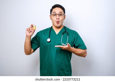 Surprised Asian Male Nurse Or Doctor Pointing And Showing Urine Pot Sample Isolated Over White Background